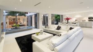 Premium open plan living room with a discreet ducted air conditioning grille in the ceiling